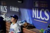 Los Angeles Dodgers designated hitter Shohei Ohtani sits in the dugout during the ninth inning of Game 3 of baseball's National League Championship Series between the Milwaukee Brewers and the Los Angeles Dodgers, Wednesday, Oct. 14, 2026, in Los Angeles. (AP Photo/Ashley Landis)