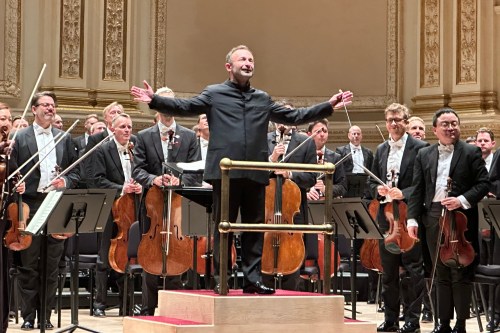 This image taken with a smartphone shows Kirill Petrenko, chief conductor of the Berlin Philharmonic, during a concert with the orchestra at Carnegie Hall in New York on Oct. 10, 2026. (AP Photo/Ron Blum)