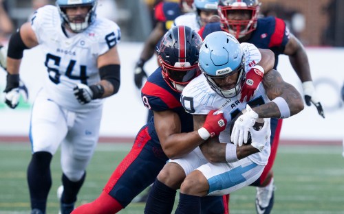 Toronto Argonauts' Kevin Mital (10) is tackled by Montreal Alouettes' Geoffrey Cantin-Arku (9) during first half CFL football action in Montreal on Friday, June 12, 2026. THE CANADIAN PRESS/Christinne Muschi