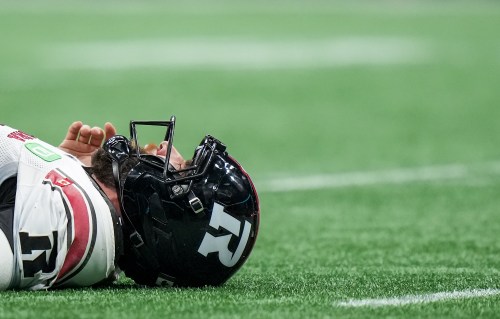 Ottawa Redblacks quarterback McLeod Bethel-Thompson lies on the field briefly after being hit by B.C. Lions' Lorenzo Mauldin IV, not seen, while passing the ball during the second half of a CFL football game, in Vancouver, on Friday, Oct. 9, 2026. THE CANADIAN PRESS/Darryl Dyck