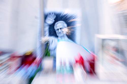 An image of Pope Leo XIV is seen under the statue of late Pope St. John Paul II at the Agostino Gemelli Polyclinic where the pontiff is hospitalised, in Rome, Friday, Oct. 16, 2026. (AP Photo/Gregorio Borgia)