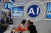 FILE -Vendors for AI enabled robots wait for customers at the 137th Canton Fair in Guangzhou in southern China's Guangdong province on April 16, 2025. (AP Photo/Ng Han Guan, File)