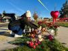 A person places flowers at a makeshift memorial on the other side of Silver Rail Elementary School in Bend, Ore., on Friday, Oct. 16, 2026, a day after a deadly shooting. (AP Photo/Haven Daley)