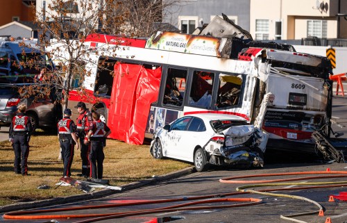 Police and fire personnel attend the scene of a fatal bus crash in Calgary, Thursday, Oct. 15, 2026.THE CANADIAN PRESS/Jeff McIntosh