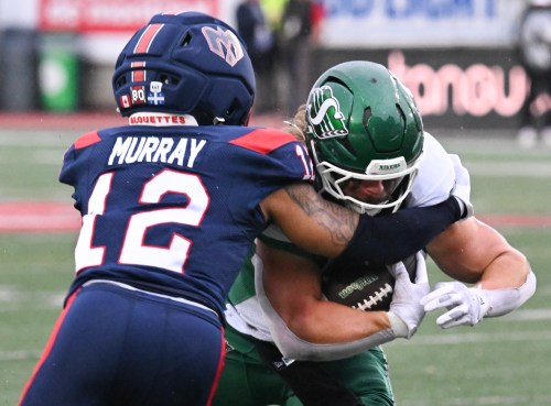 Saskatchewan Roughriders' A.J. Ouellette, right, is tackled by from Montreal Alouettes' Najee Murray (12) during second half CFL football action in Montreal, on Monday, Oct. 12, 2026. THE CANADIAN PRESS/Graham Hughes