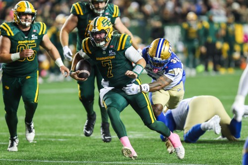 Edmonton Elks' quarterback Cody Fajardo (7) is tackled by Winnipeg Blue Bombers' Michael Griffin II (32) during first half CFL football action in Edmonton on Friday, Oct. 16, 2026. THE CANADIAN PRESS/Codie McLachlan