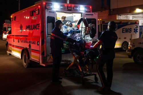 Paramedics load an injured person into an ambulance at the Wainwright Health Centre as injured military members are treated after a fire at CFB Wainwright, outside of Wainwright, Alta., on Saturday, Oct. 17, 2026. THE CANADIAN PRESS/John Ulan