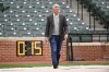FILE - Baltimore Orioles general manager Mike Elias walks in front of a pitching clock before a game against the New York Yankees on April 8, 2023, in Baltimore. (AP Photo/Gail Burton, File)