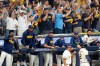 Milwaukee Brewers players and fans cheer during the eighth inning of Game 2 of baseball's National League Championship Series between the Milwaukee Brewers and the Los Angeles Dodgers, Monday, Oct. 12, 2026, in Milwaukee. (AP Photo/Kayla Wolf)