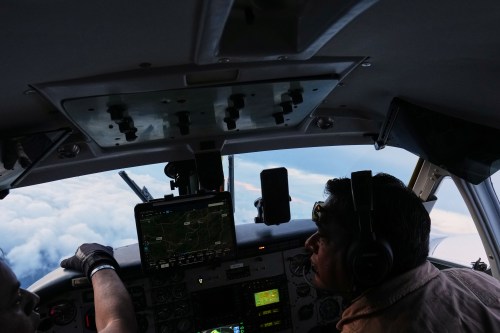 Pilots Victor Torres from Mexico, right, and Jose Torres from Honduras fly an aircraft during a cloud seeding mission aimed at inducing rain as part of the Honduran government's efforts to address a prolonged drought at the Aguan river, in northern Honduras, Wednesday, Oct. 14, 2026. (AP Photo/Moises Castillo)