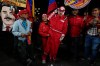 FILE - A PDVSA worker of the state-owned oil company carries a cutout of former President Nicolas Maduro dressed as an oil worker during a rally to back an oil reform bill proposed by acting President Delcy Rodriguez to loosen state control and open the industry to private and foreign investment in Caracas, Venezuela, Jan. 29, 2026. (AP Photo/Ariana Cubillos, File)