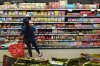 FILE - A customer buys Chinese made ginger candy at 99 Ranch Market, an Asian grocery store in Los Angeles, April 7, 2025. (AP Photo/Damian Dovarganes, File)