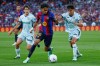 Barcelona's Lamine Yamal, centre, challenges for the ball with Getafe's Ramon Terrats, right, during the Spanish La Liga soccer match between Barcelona and Getafe in Barcelona, Spain, Saturday, Oct. 10, 2026. (AP Photo/Joan Monfort)