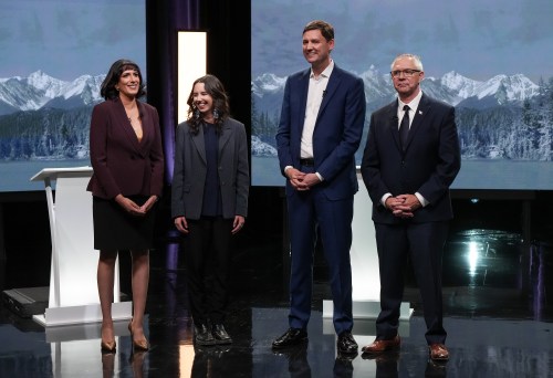 Moderator Shachi Kurl, from left to right, B.C. Green Party Leader Emily Lowan, B.C. NDP Leader David Eby and B.C. Conservative interim Leader Lorne Doerkson stand together after the televised B.C. Leaders' Debate ahead of the provincial election, in Vancouver, on Wednesday, Oct. 14, 2026. THE CANADIAN PRESS/Darryl Dyck