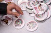 A person picks up a button during a 