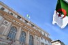 Algerian flags are waved outside the parliament building in Algeria, Sunday, Oct. 25, 2026. (AP Photo/Fateh Guidoum)