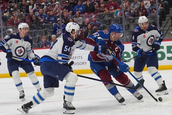 Colorado Avalanche forward Gabriel Landeskog (centre) drives past Winnipeg Jets defenceman Dylan Samberg (left) to shoot on Jets goalie Stuart Skinner, during a game in Denver, in September. (David Zalubowski / The Associated Press)