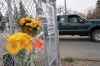 Flowers are placed at the entrance to Canadian Forces Base Wainwright in Alberta, Canada, Monday, Oct. 19, 2026. (AP Photo/Ty O'Neil)